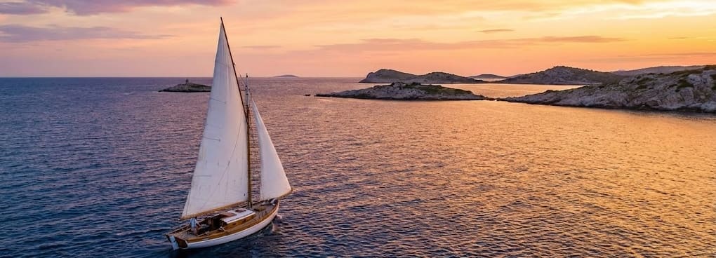 Cruising yacht at sunset on open water